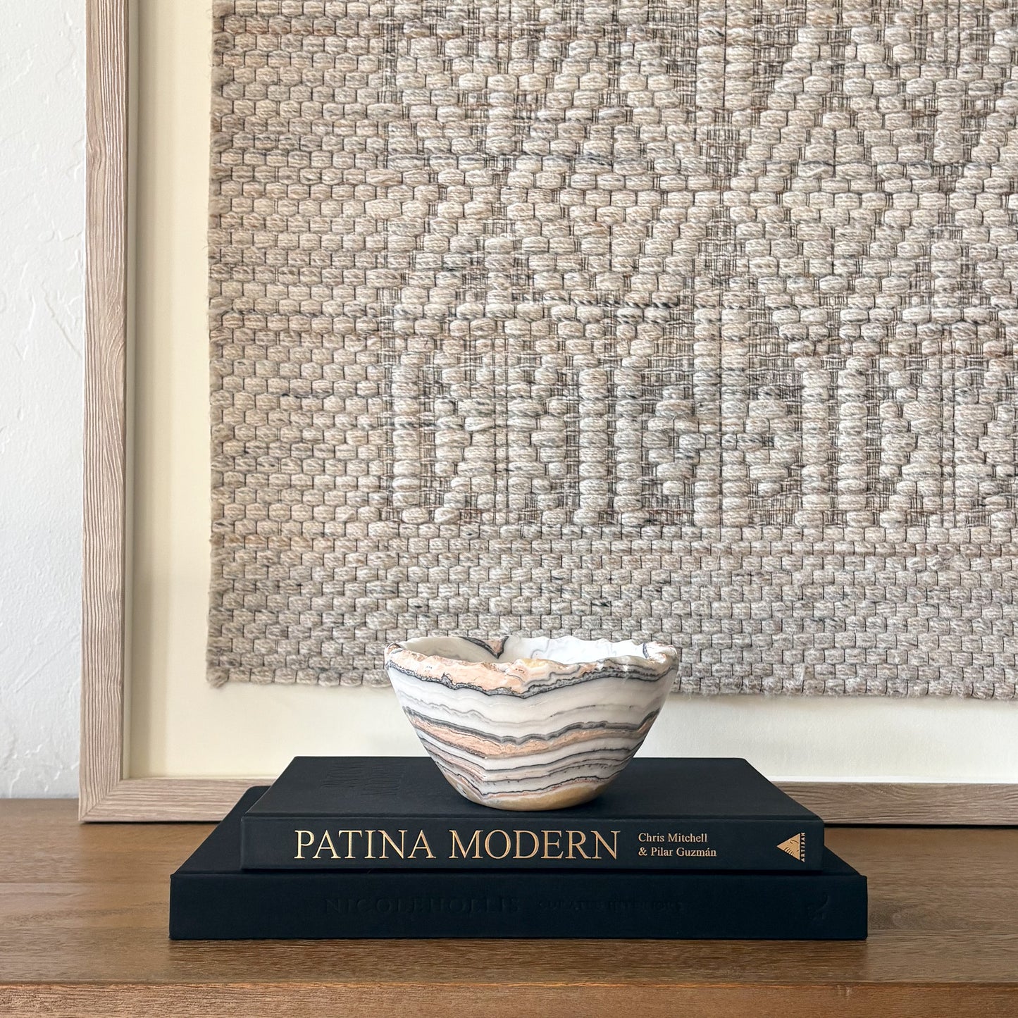 Artisan carved zebra calcite bowl in neutral tones styled for modern home decor