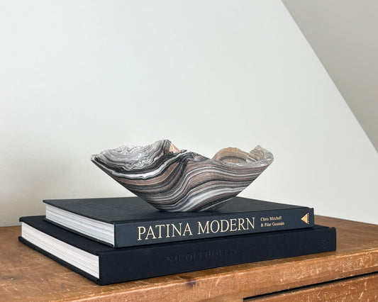 Hand-carved zebra onyx bowl with dramatic black, taupe, white, and grey natural banding