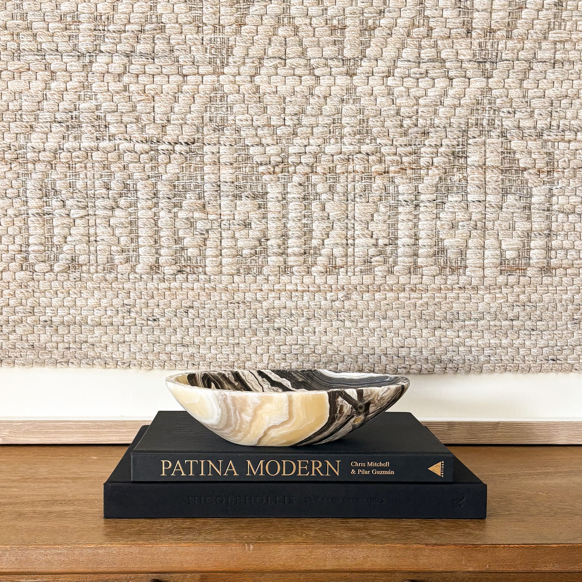 Polished zebra onyx bowl with bold black and white veining in modern home decor setting