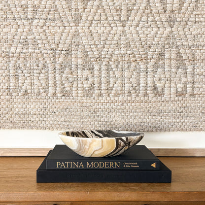 Polished zebra onyx bowl with bold black and white veining in modern home decor setting