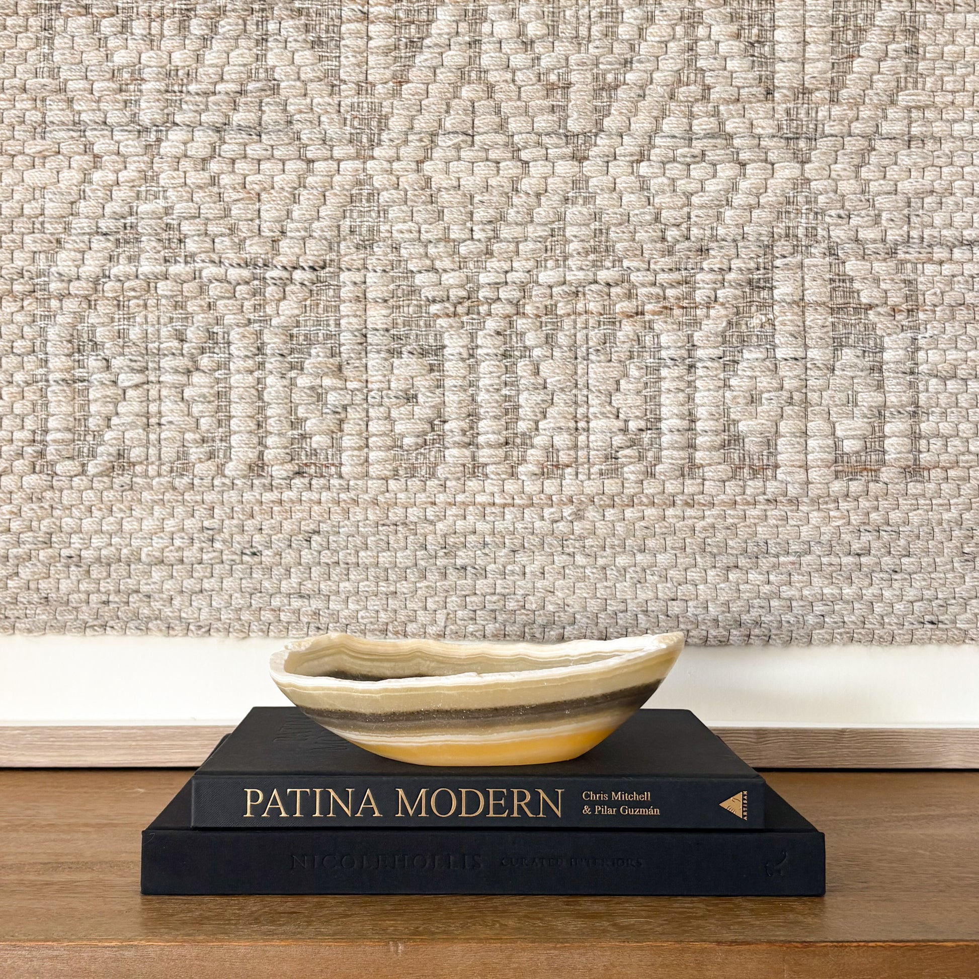 Decorative small zebra onyx bowl styled with interior design books