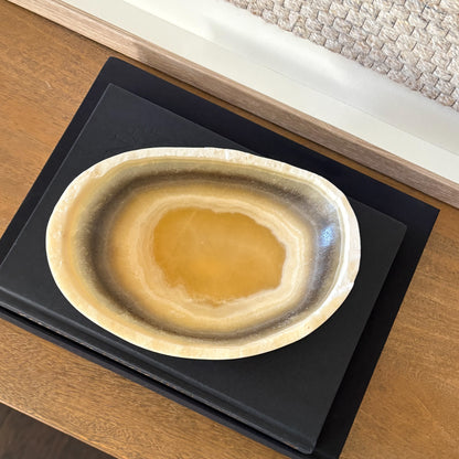 Polished zebra onyx bowl with bold black and white veining in modern home decor setting