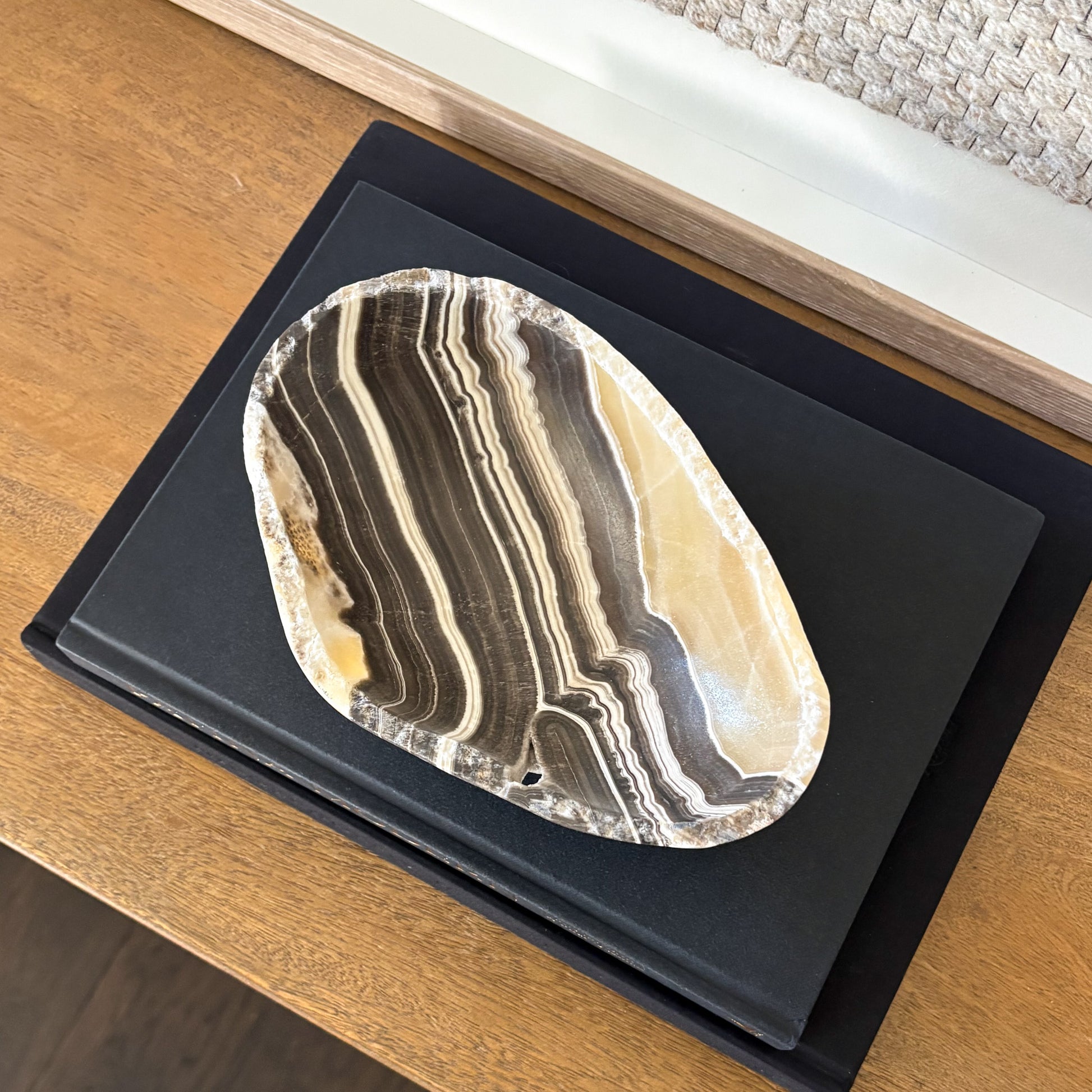 Decorative small zebra onyx bowl styled with interior design books