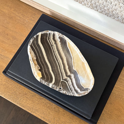 Decorative small zebra onyx bowl styled with interior design books