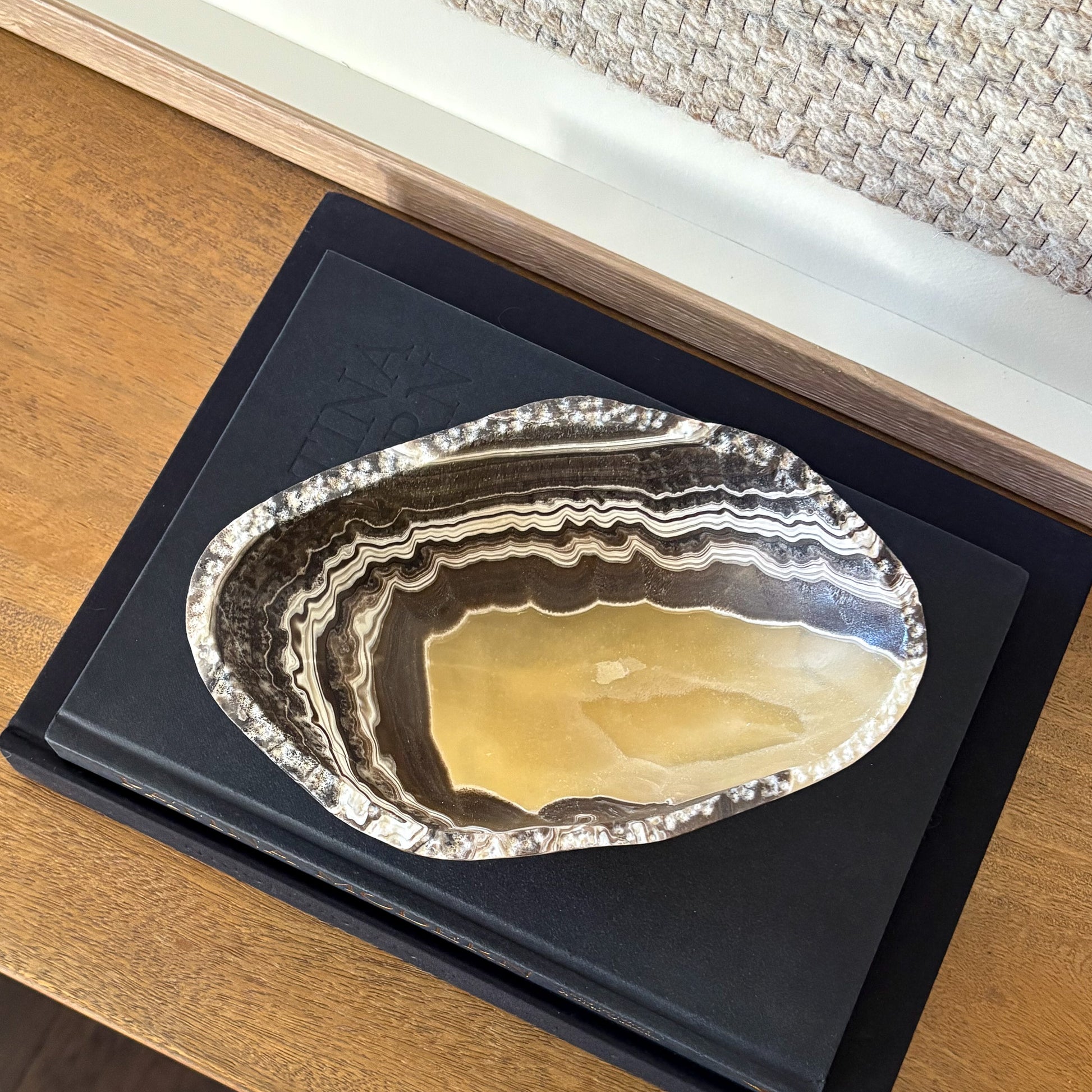 Decorative small zebra onyx bowl styled with interior design books