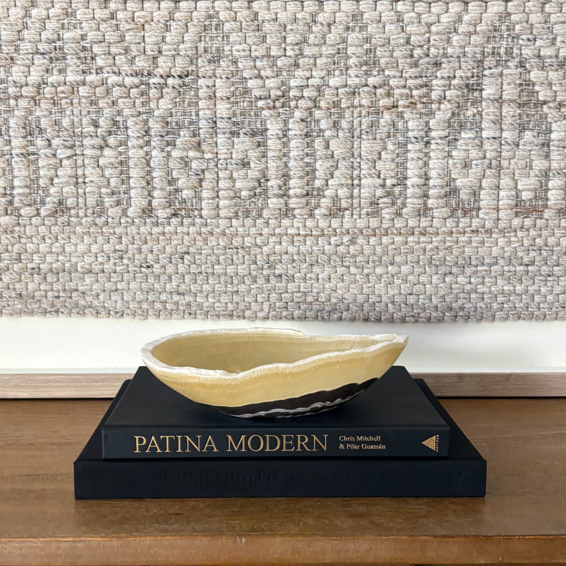 Small zebra onyx decorative bowl with natural striped stone pattern on wooden console