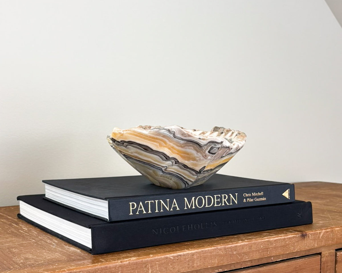 Hand-carved natural stone bowl with intricate zebra onyx patterns in yellow, grey and black