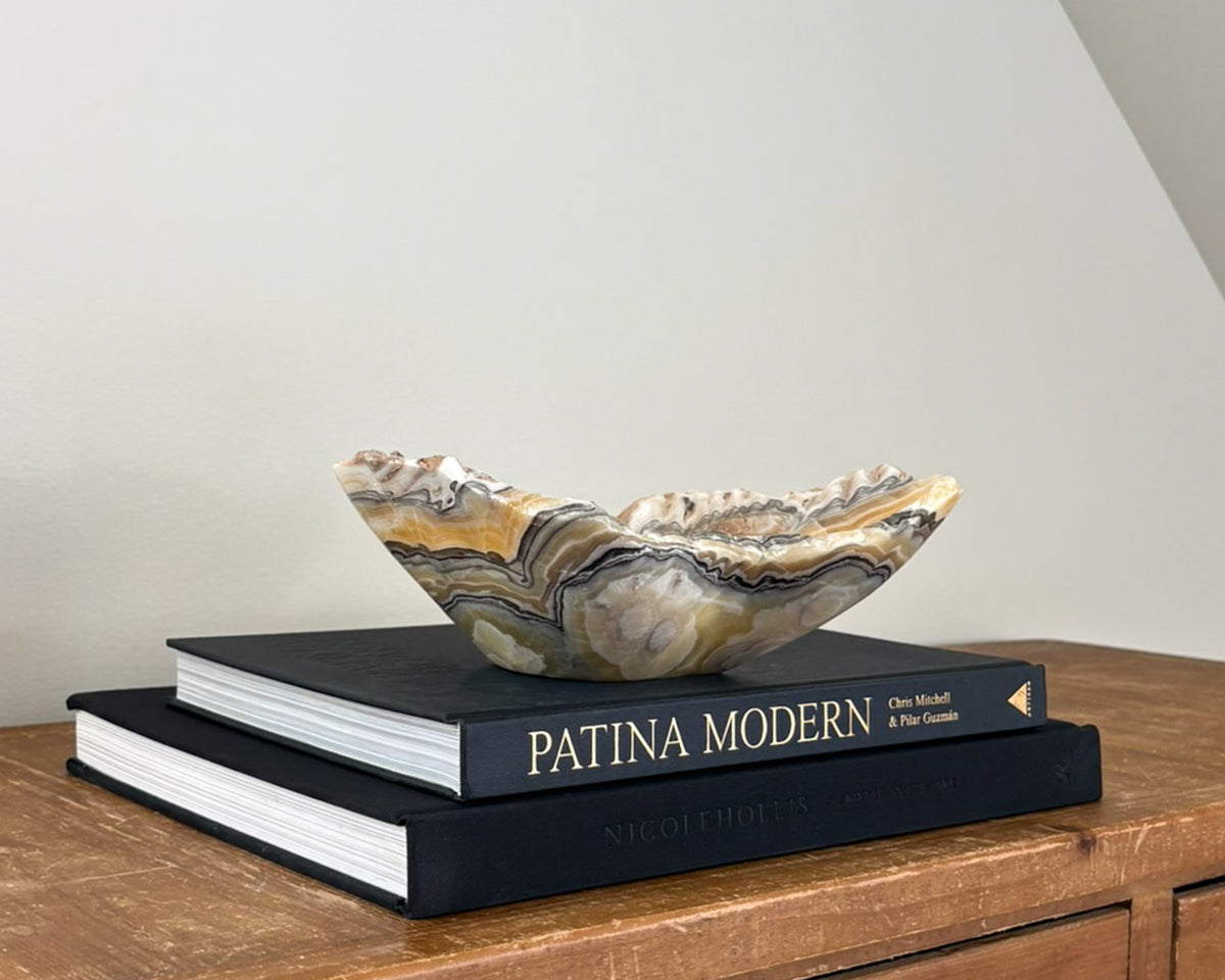 Polished zebra onyx bowl showcasing golden yellow, charcoal grey, black and ivory veining