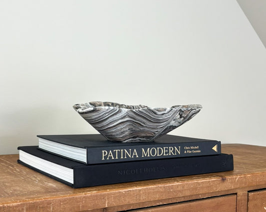 Hand-carved zebra onyx bowl with freeform edges and intricate black, grey, ivory and taupe banding