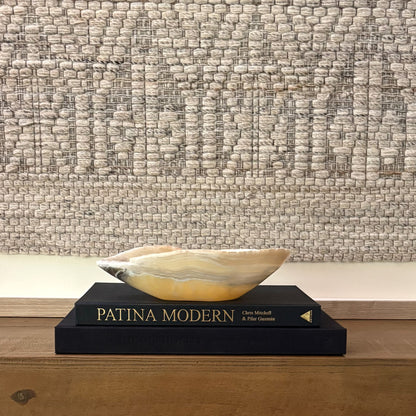 Hand-carved zebra onyx bowl used as a decorative centerpiece with bold natural stone veining