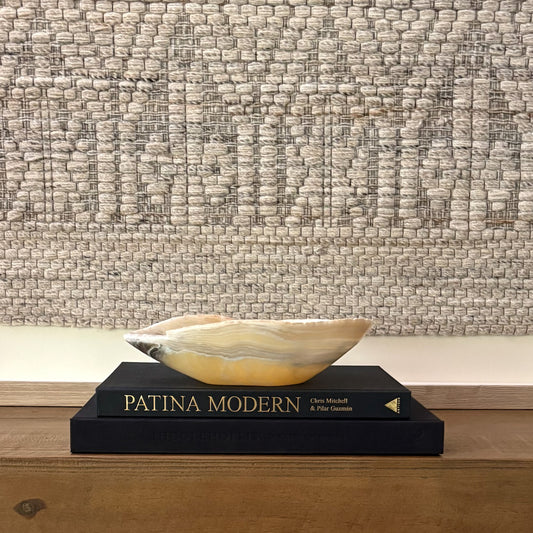 Hand-carved zebra onyx bowl used as a decorative centerpiece with bold natural stone veining