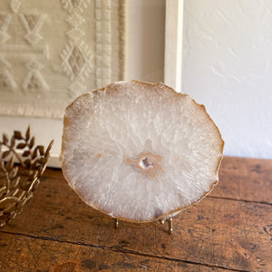 large white agate crystal geode slab on stand