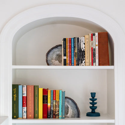 Handcrafted blue Brazilian agate bookend pair displayed among books in a modern living room bookshelf.