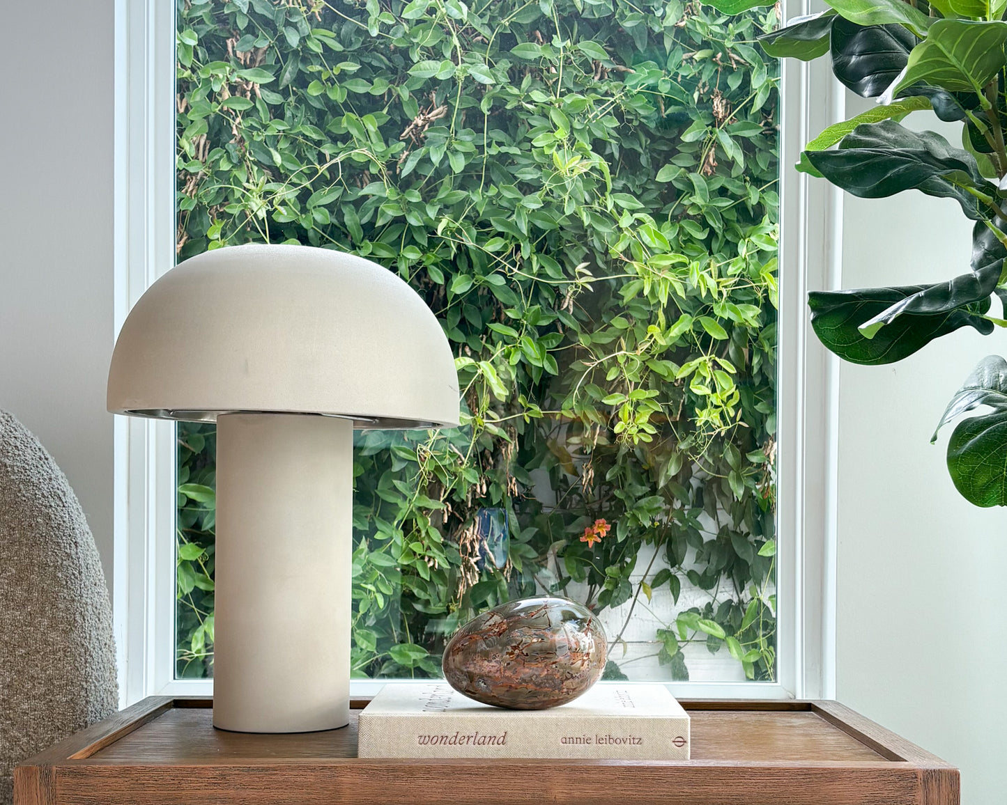 Large polished Ibis Jasper egg sculpture styled on a bookshelf with modern home décor