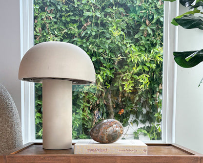 Polished Ibis Jasper egg with intricate natural patterns on a designer coffee table book
