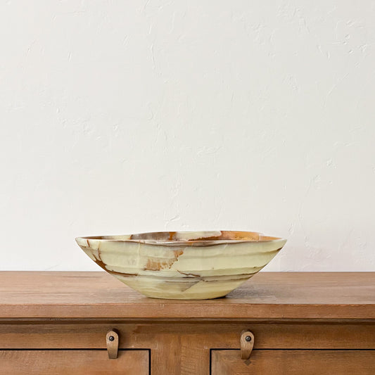 Decorative polished green onyx centerpiece bowl featuring organic freeform edges and earthy natural stone patterns.