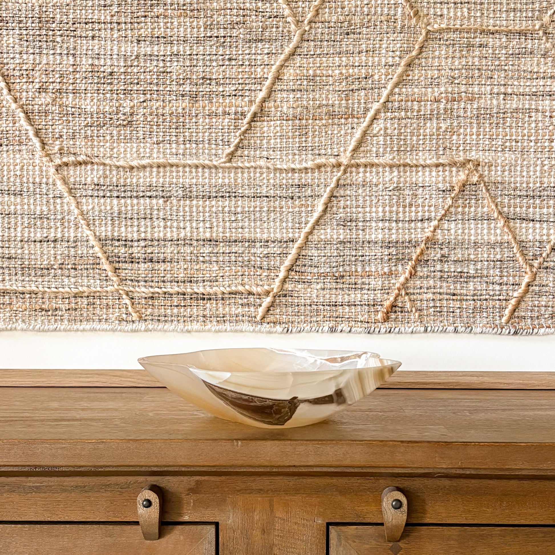 Large hand-carved amber onyx bowl featuring natural banded stone patterns and warm golden hues