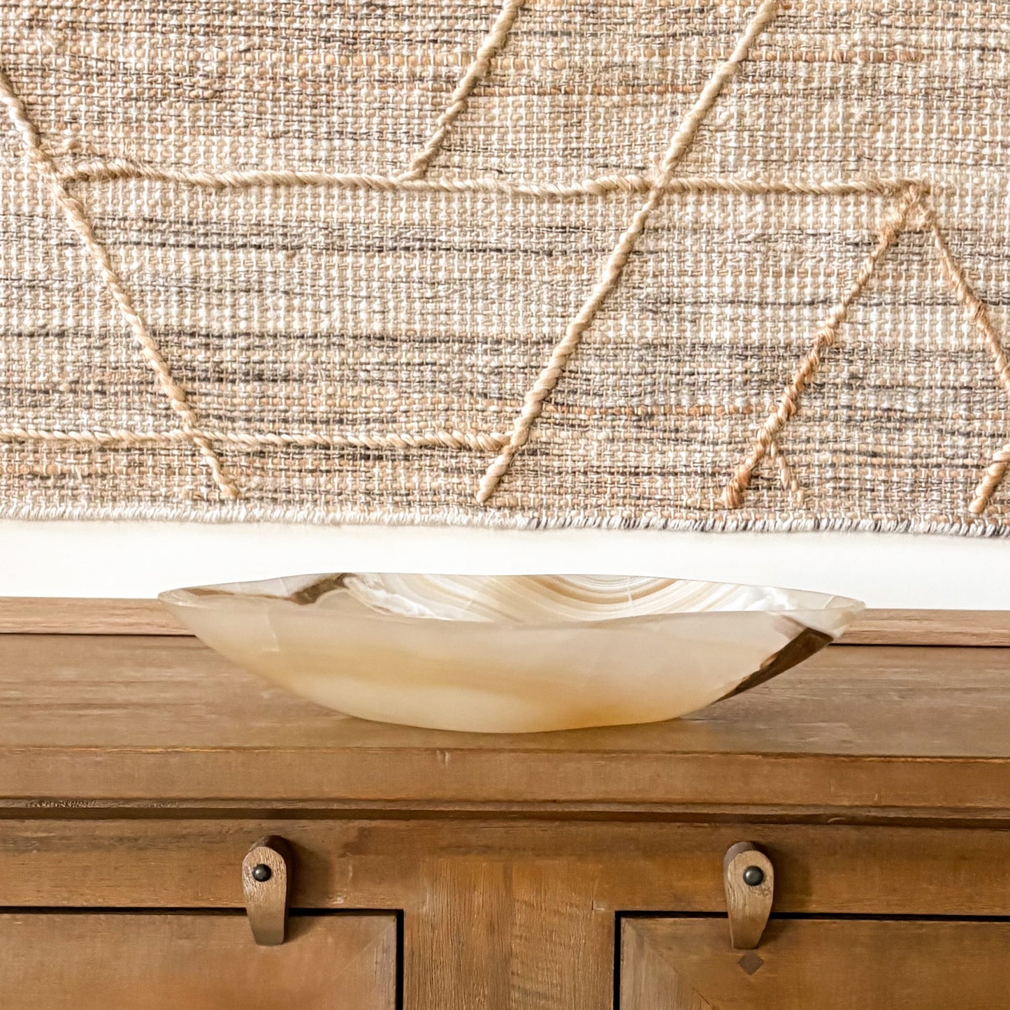 Artisan-crafted amber onyx bowl with natural veining, smooth polished surface, and translucent golden hues, ideal as a decorative centerpiece