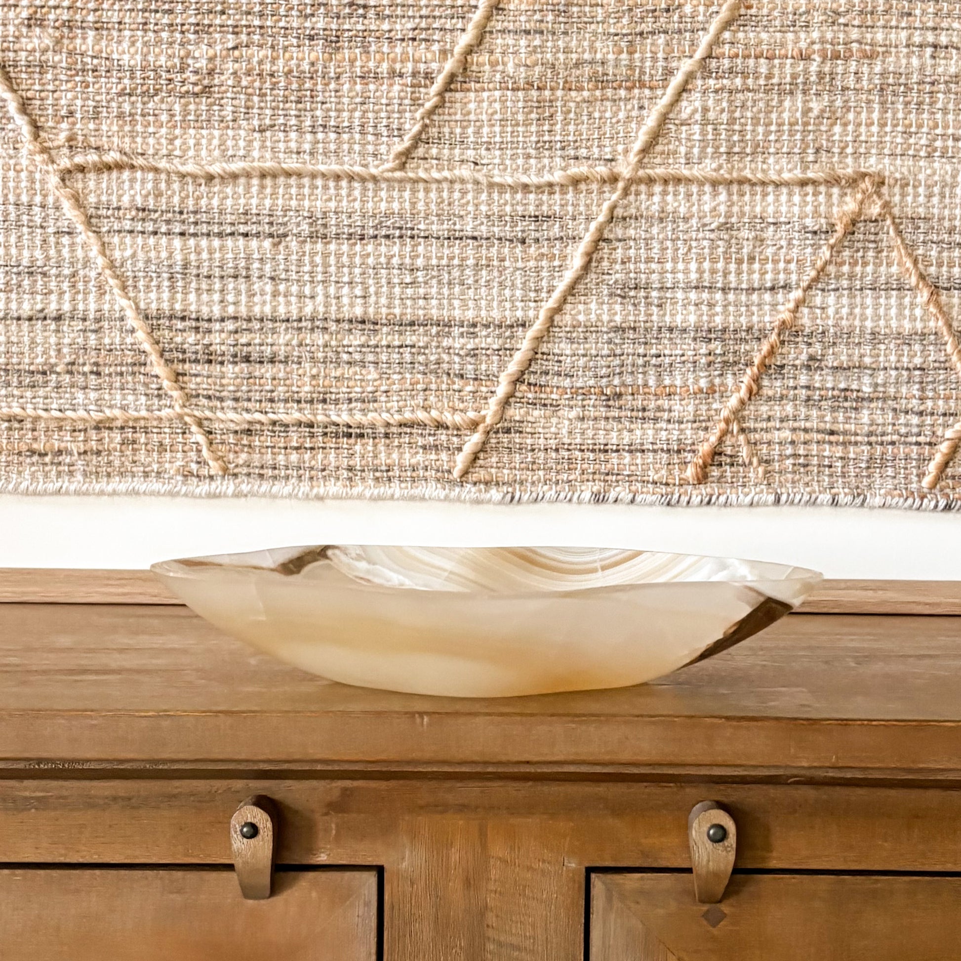 Artisan-crafted amber onyx bowl with natural veining, smooth polished surface, and translucent golden hues, ideal as a decorative centerpiece
