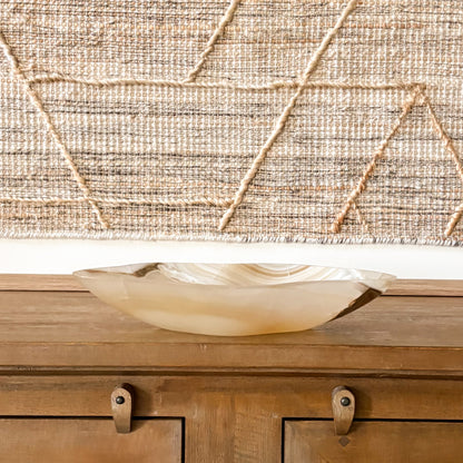 Artisan-crafted amber onyx bowl with natural veining, smooth polished surface, and translucent golden hues, ideal as a decorative centerpiece