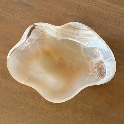 Large hand-carved amber onyx bowl made from natural stone, featuring unique banded patterns, warm golden tones, and a polished finish for home decor