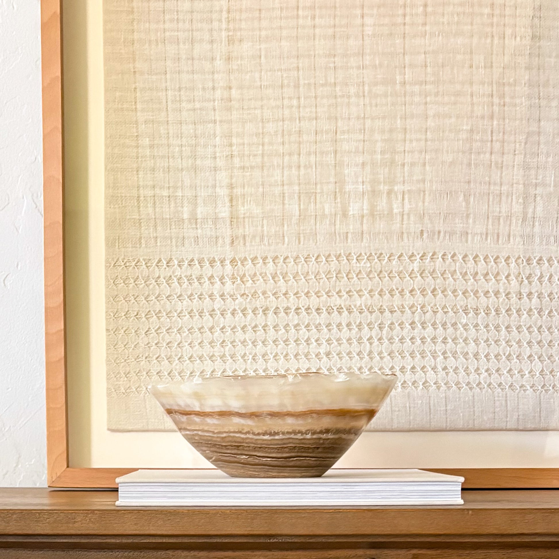 Hand-carved amber onyx bowl with natural stone patterns and polished finish