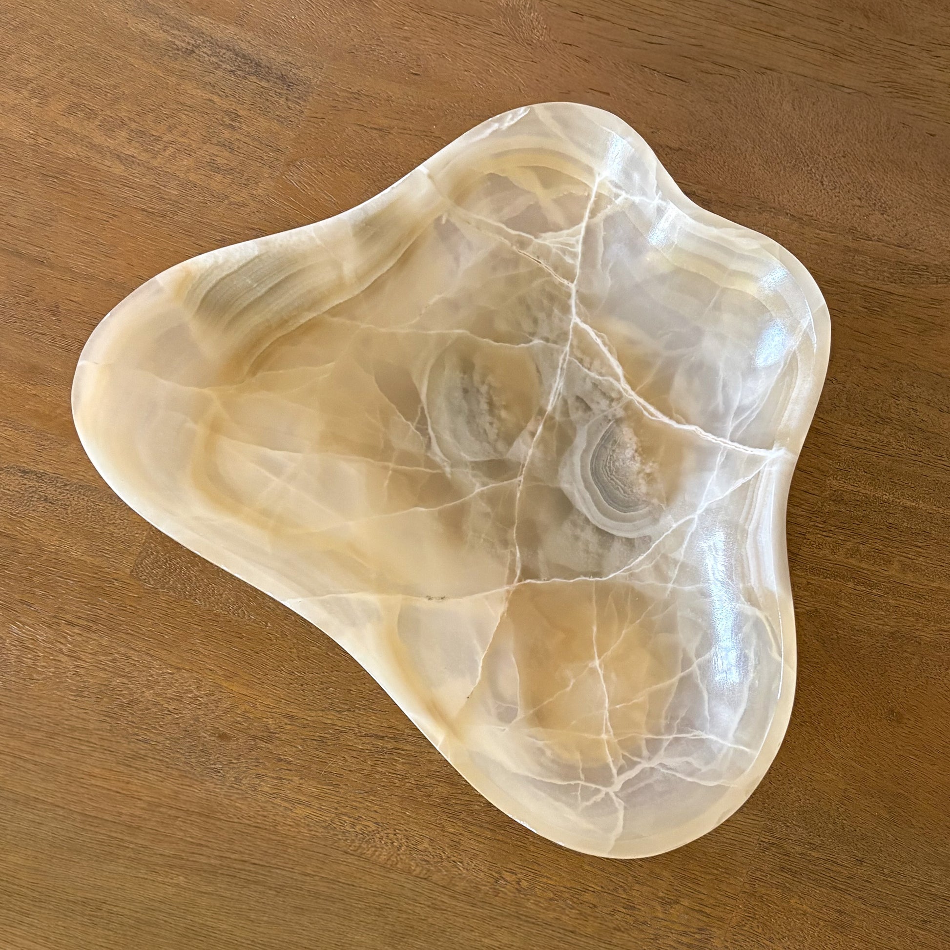 Decorative stone bowl for entryway table styling with natural amber tones