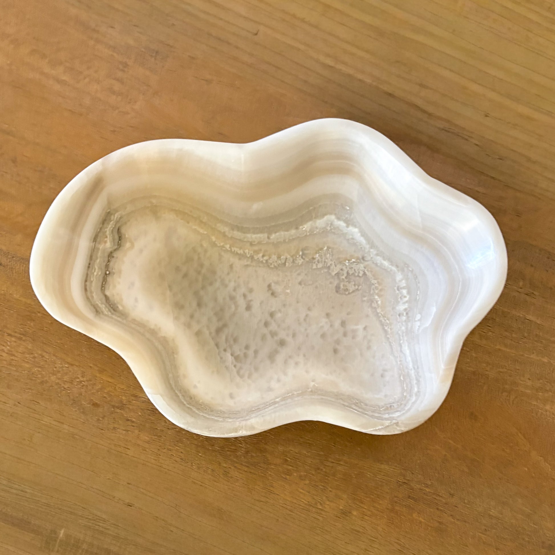 Artisan carved grey onyx bowl showcasing organic stone textures