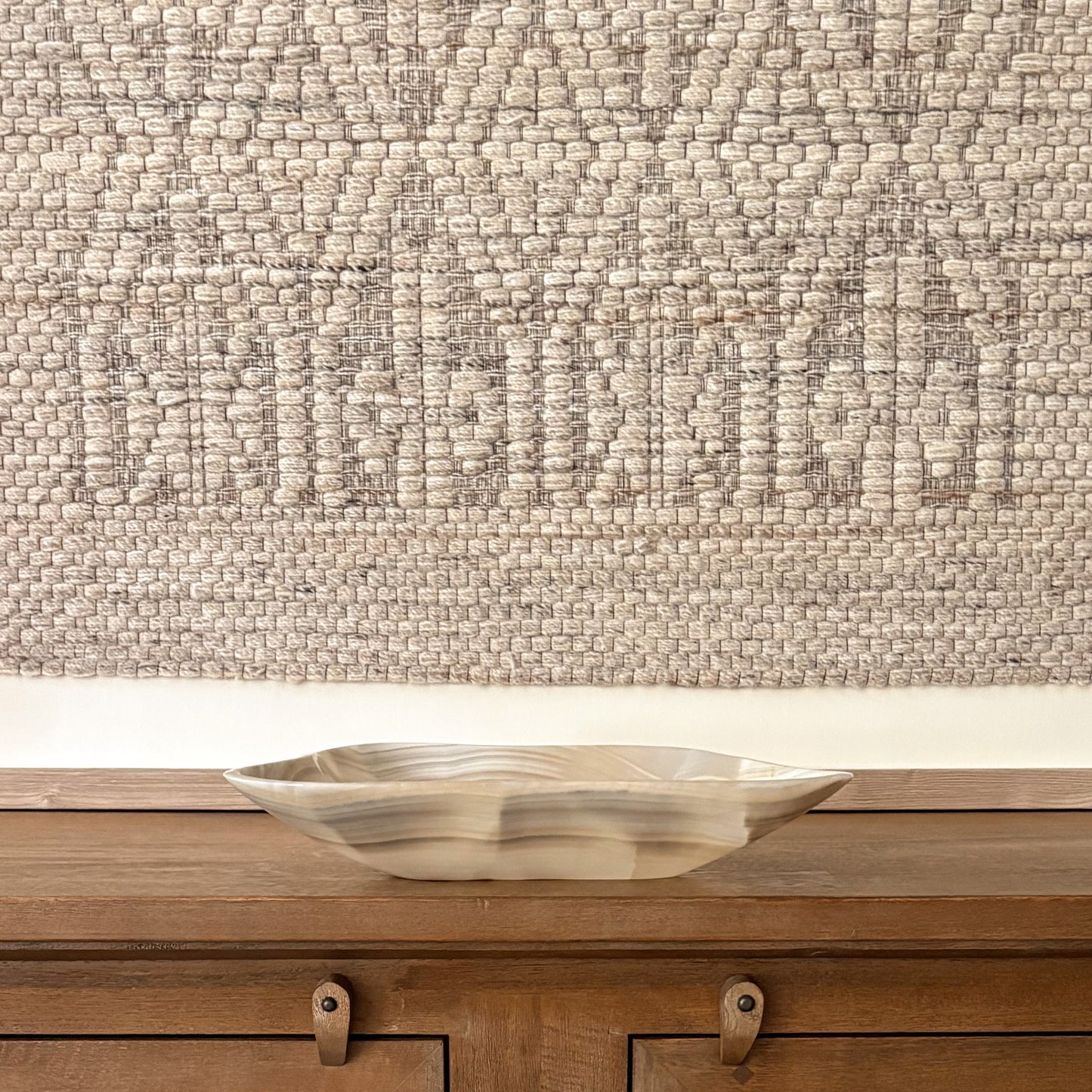 Large hand carved grey onyx bowl displayed as a luxury decorative centerpiece with natural stone veining
