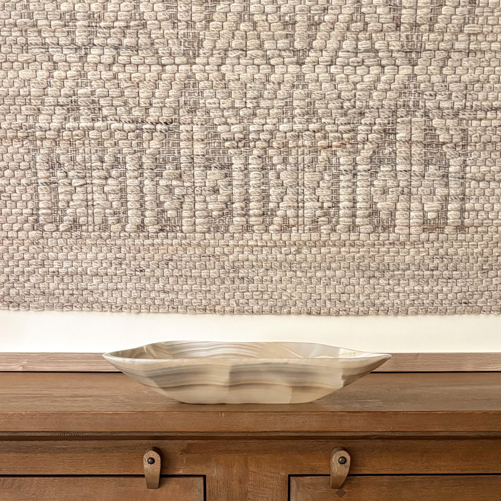 Large hand carved grey onyx bowl displayed as a luxury decorative centerpiece with natural stone veining