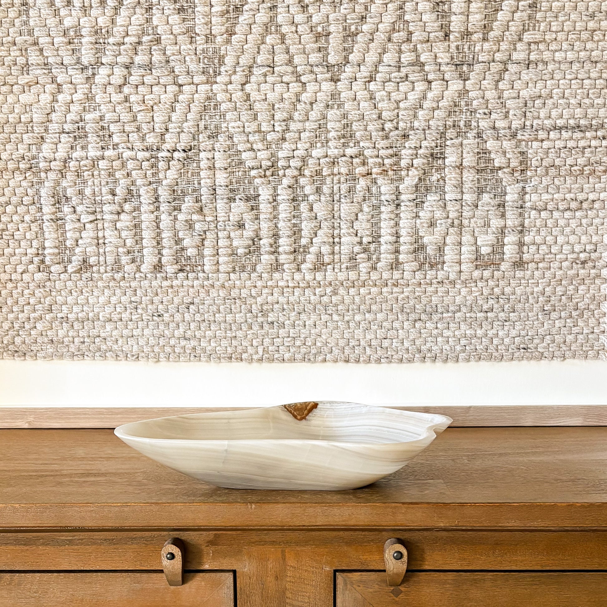 Carved grey onyx bowl showcasing natural mineral veining