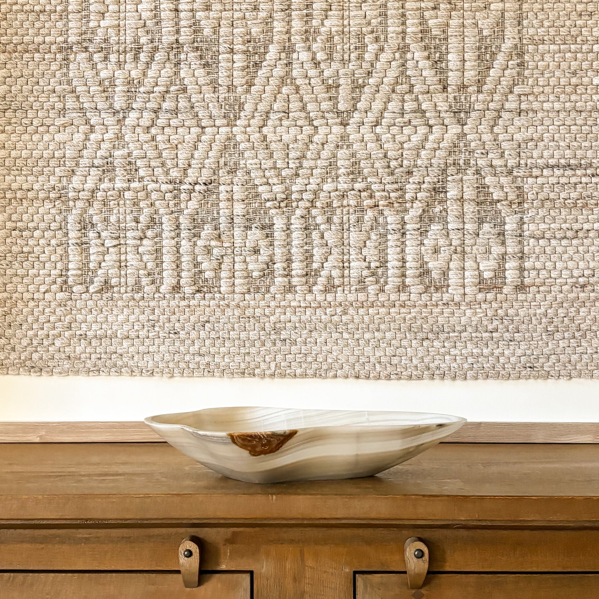 Large carved grey onyx bowl with natural stone patterns and polished finish