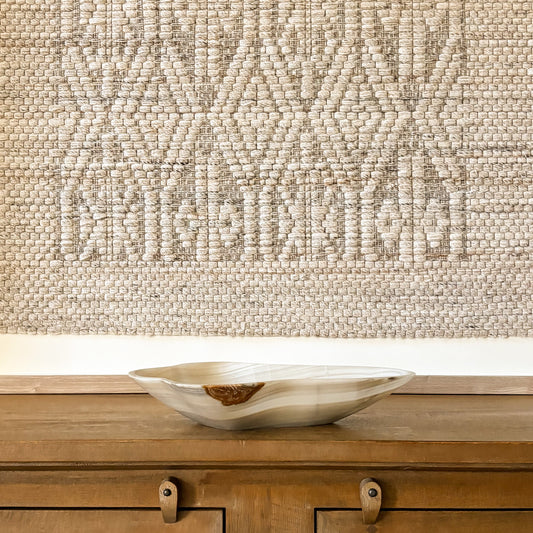 Large carved grey onyx bowl with natural stone patterns and polished finish