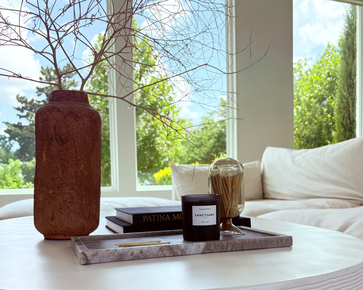 Decorative large Pocahontas marble tray with natural gray and taupe veining, styled as a luxury coffee table centerpiece.
