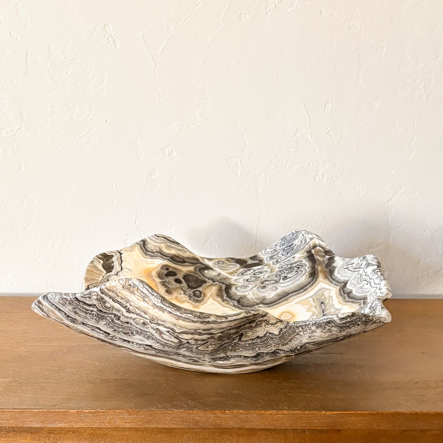 Large polished zebra onyx bowl hand carved from natural banded stone, elegant decorative centerpiece bowl.