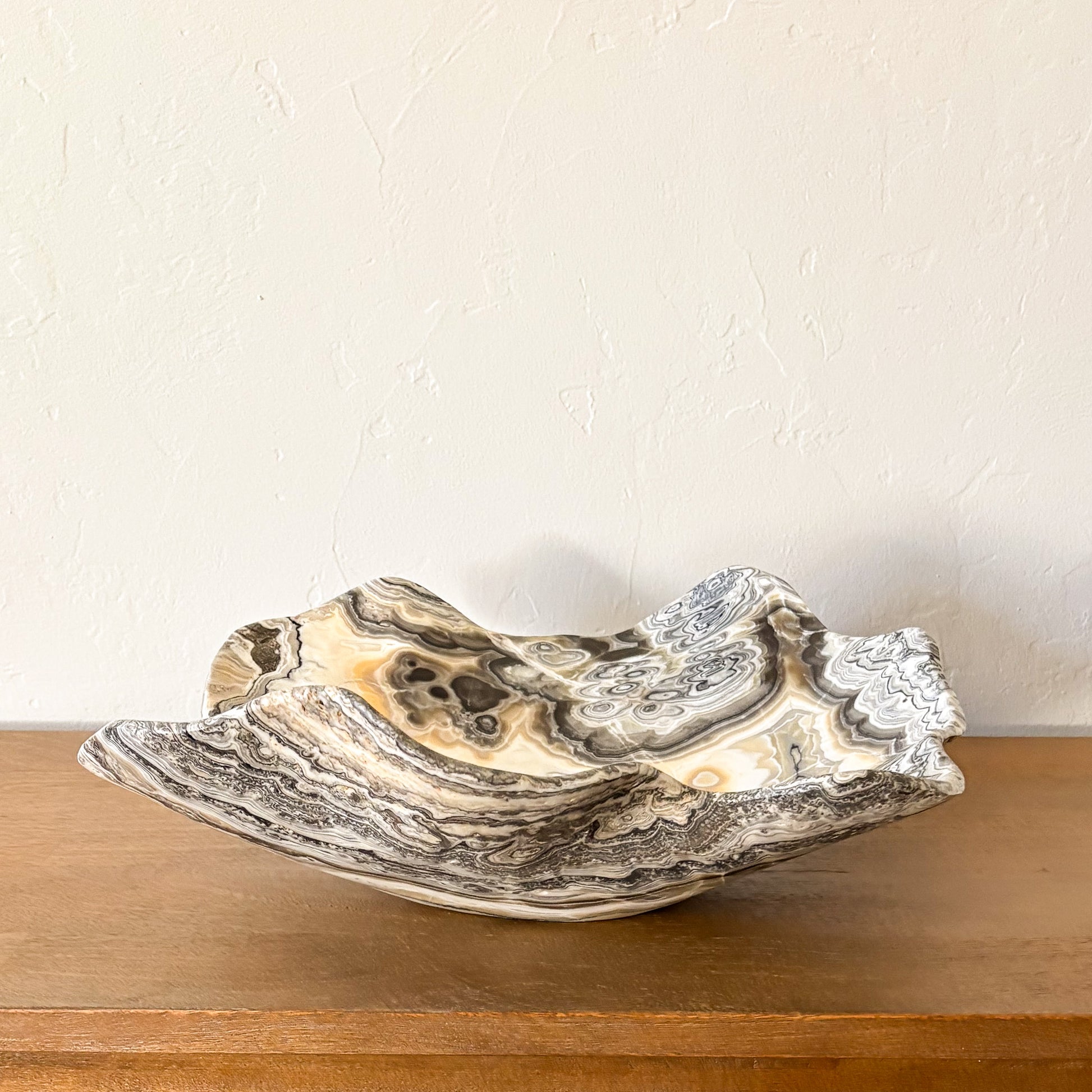 Large polished zebra onyx bowl hand carved from natural banded stone, elegant decorative centerpiece bowl.
