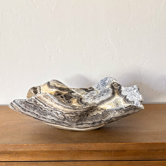 Large hand-carved zebra onyx bowl with natural black and cream banding, polished stone decorative centerpiece.