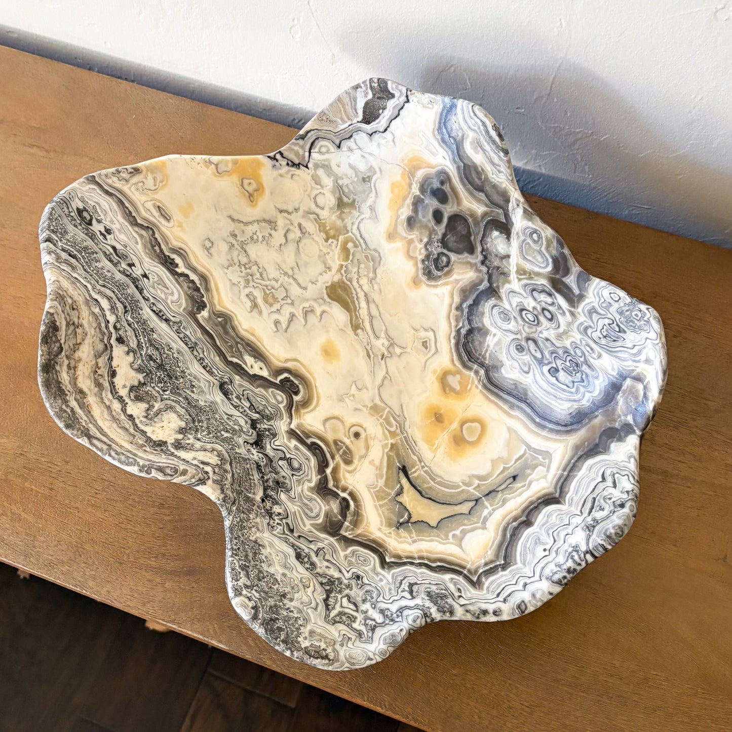 Large decorative zebra onyx bowl hand carved from natural stone with intricate cream, gray, and black patterns.