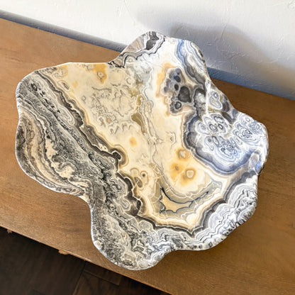 Large decorative zebra onyx bowl hand carved from natural stone with intricate cream, gray, and black patterns.