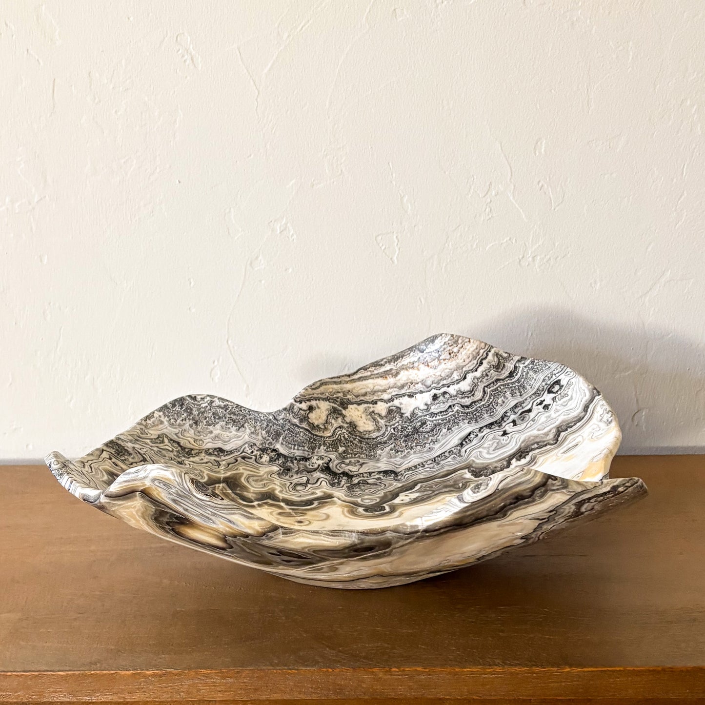Hand carved zebra onyx stone bowl with dramatic striped pattern, luxury natural stone centerpiece for home décor.