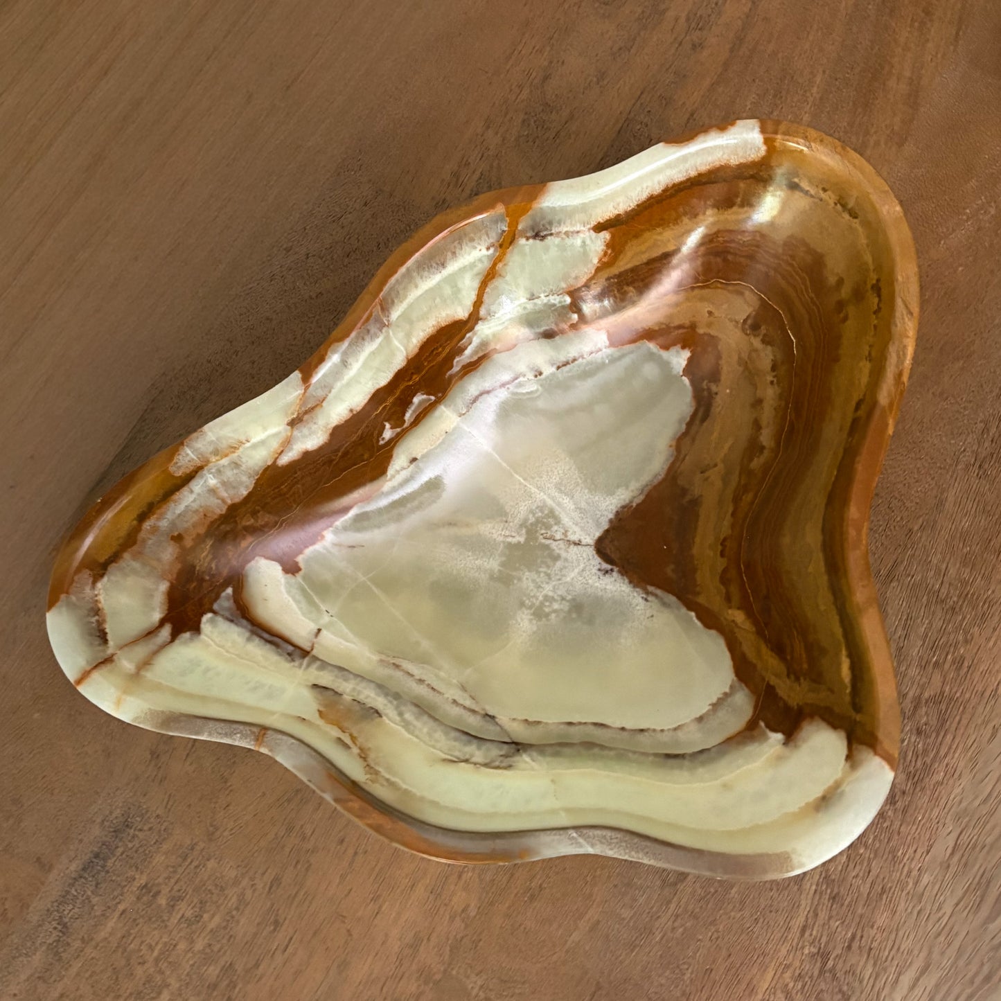 Large freeform natural stone bowl handcrafted from green onyx for luxury home décor and table styling.