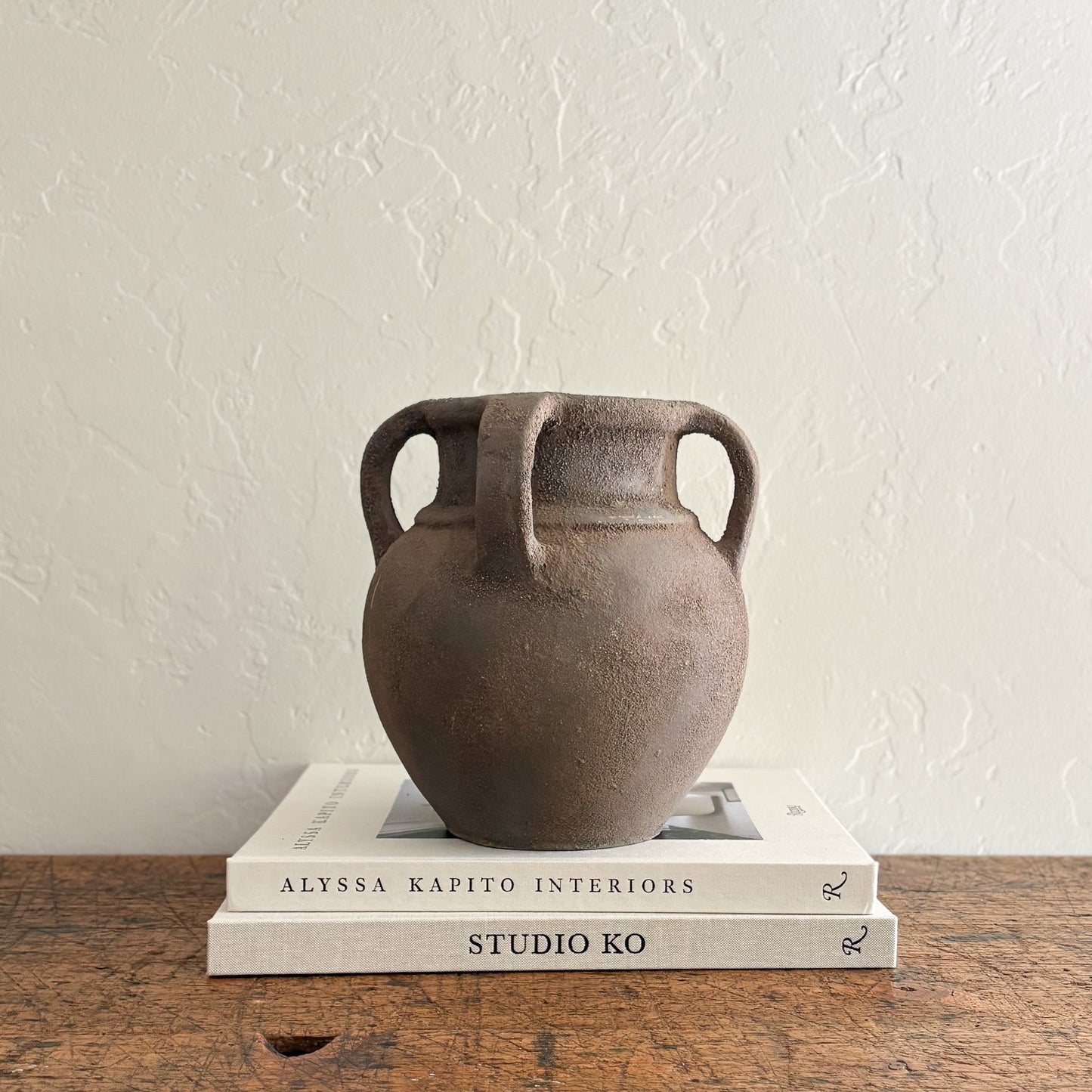 brown ceramic vase with handles