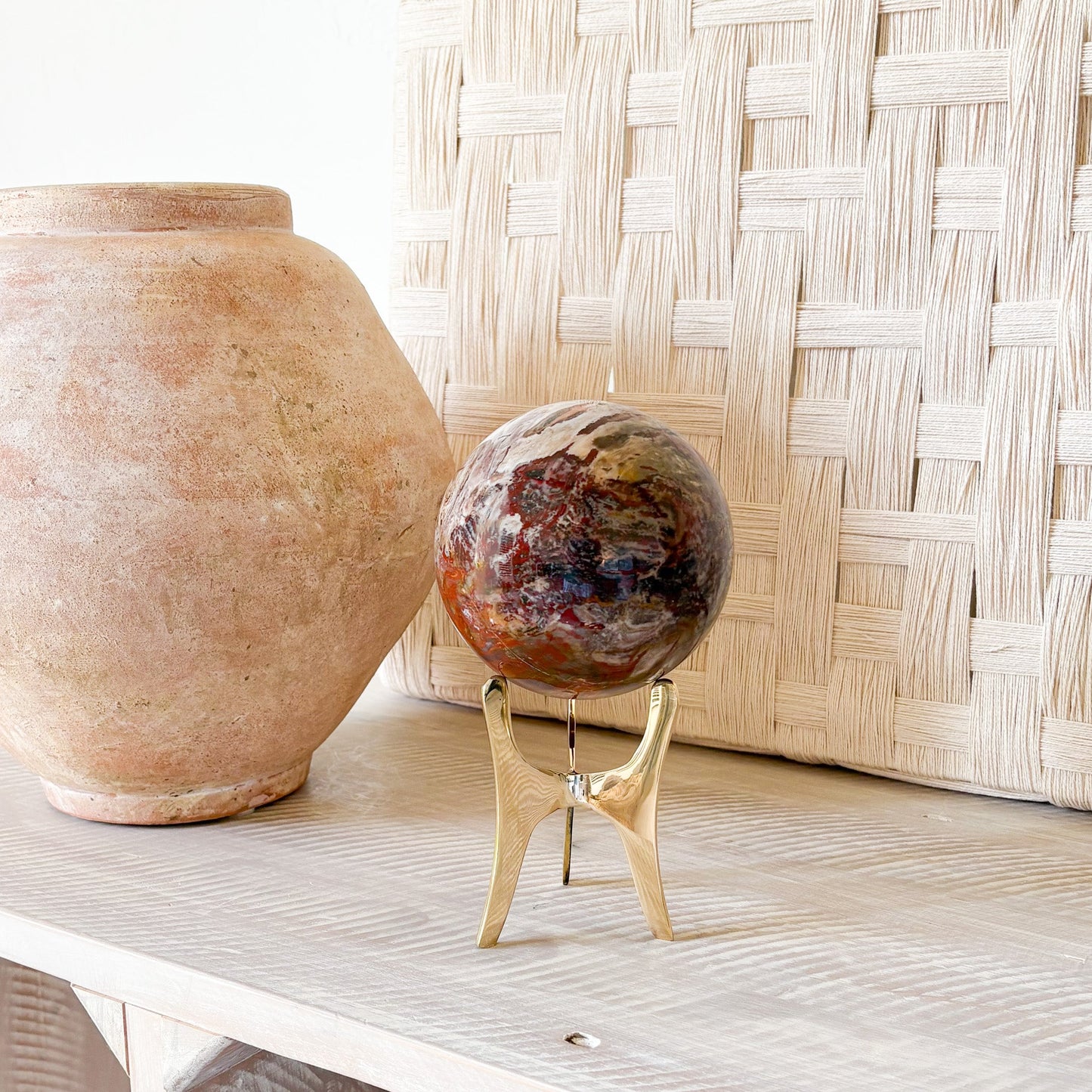 fossilized wood sphere on brass stand