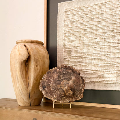 Fossilized wood slab from Madagascar with intricate crystalized patterns displayed in contemporary home setting