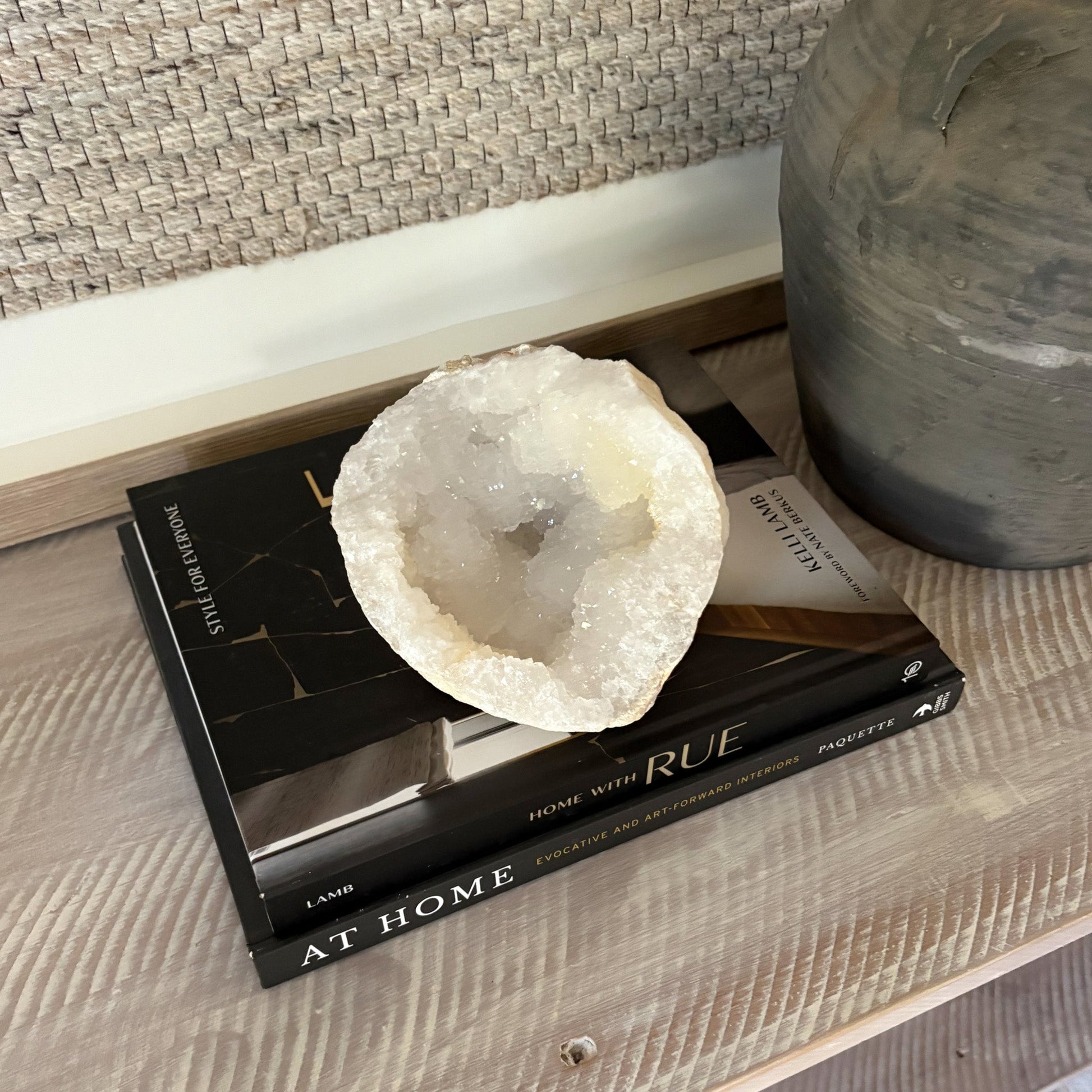 Decorative quartz geode on a book with a vase in the background