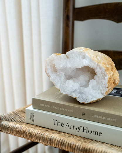 Moroccan quartz geode half styled on books as natural mineral home decor