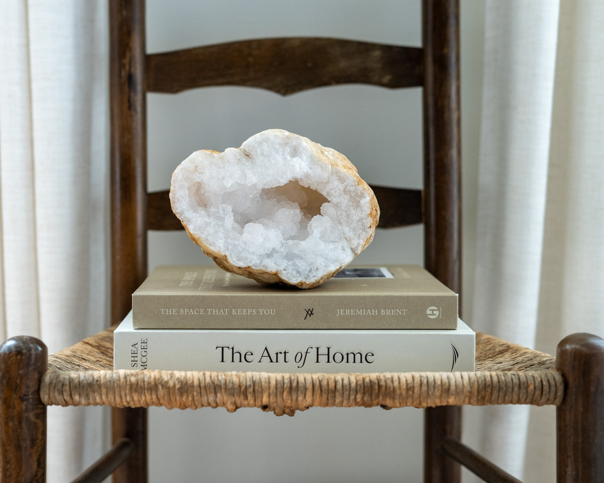 Natural quartz geode half from Morocco displayed as sculptural mineral decor