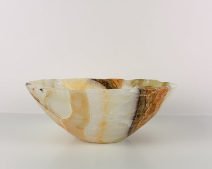 Close-up of polished olive onyx bowl with natural stone variations