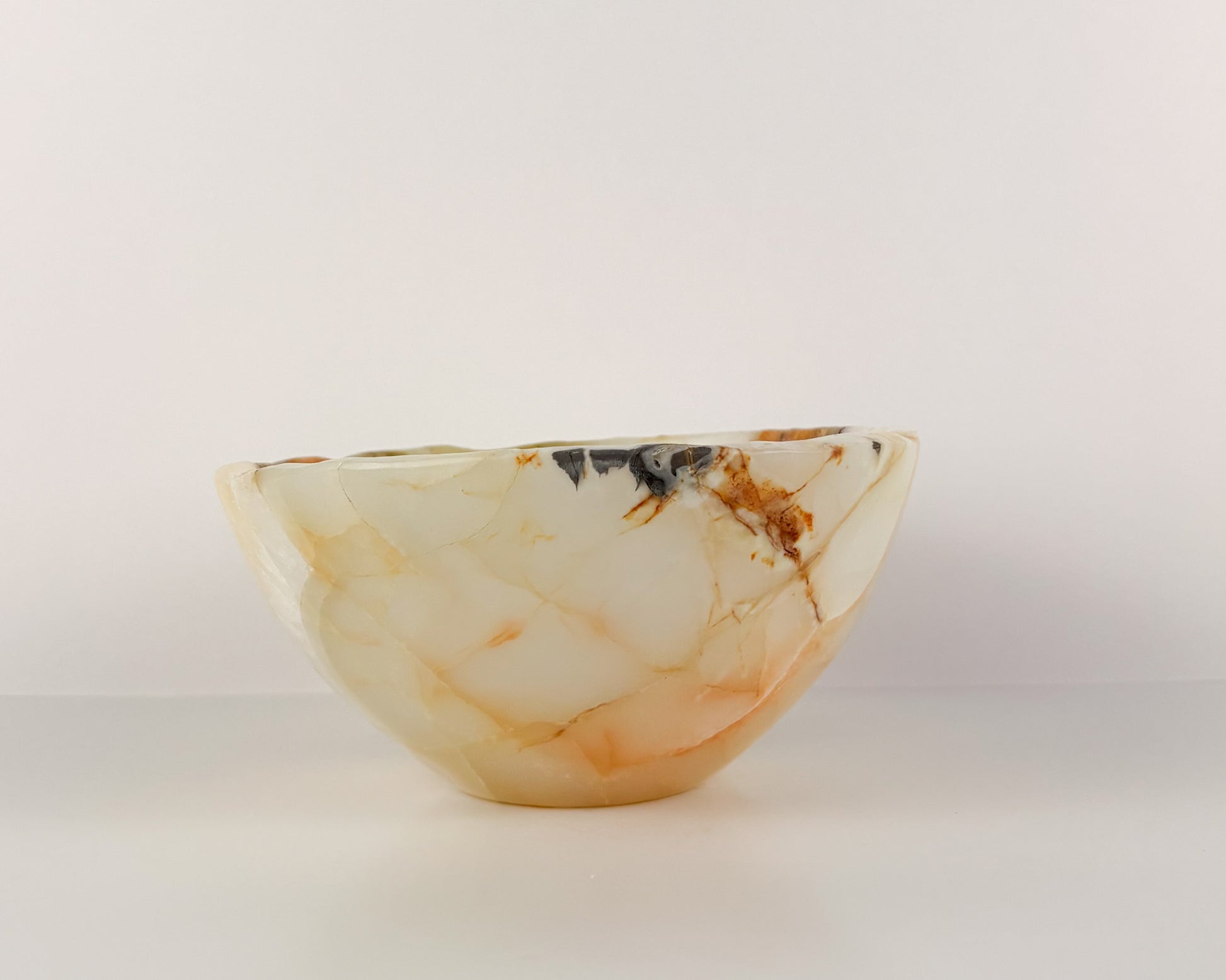 Hand-carved olive onyx decorative bowl with organic stone pattern