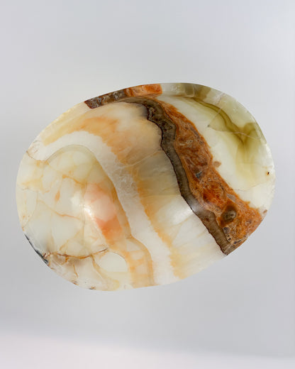 Natural onyx bowl with translucent olive green and cream tones